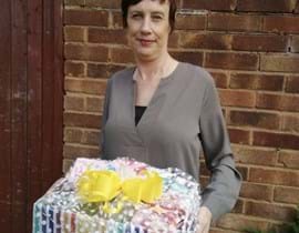 Stacey carrying a care for chemo package donated to charity