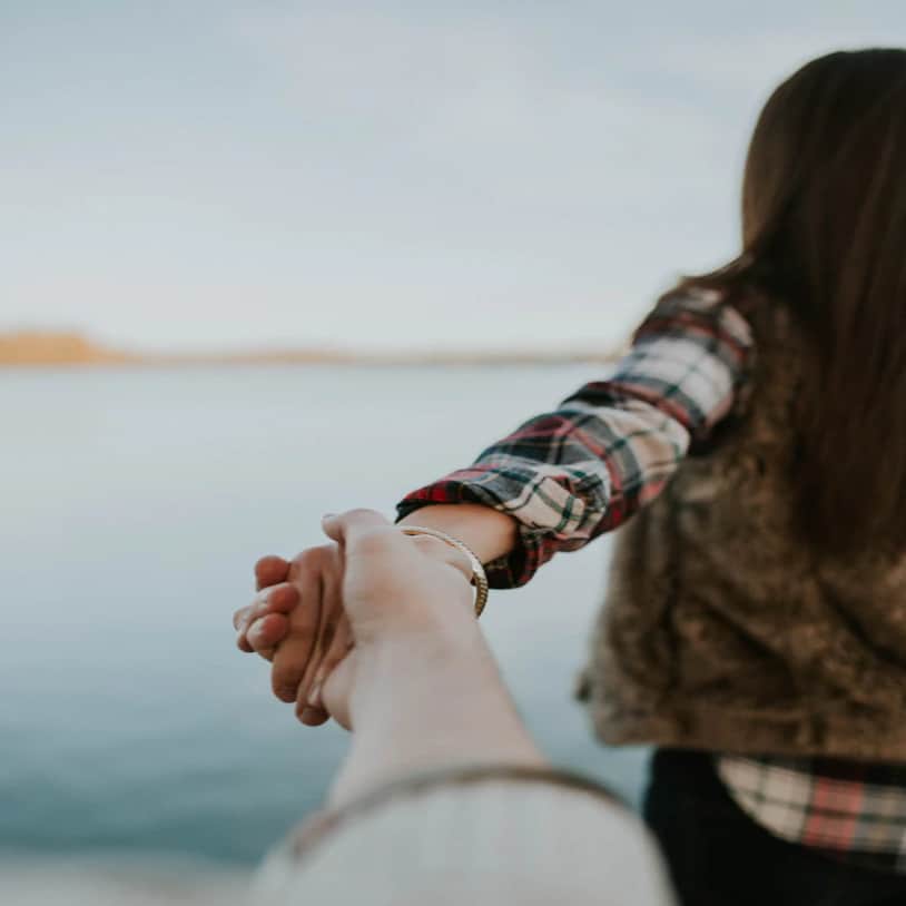 Couple holding hands walking away