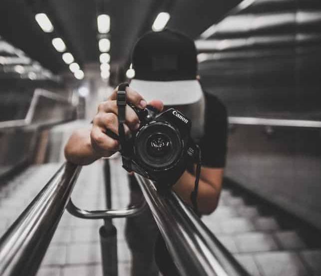 Close up of a photographer pointing his camera