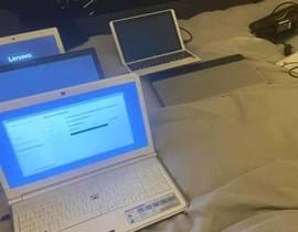 Used laptops for recycling placed on a bed
